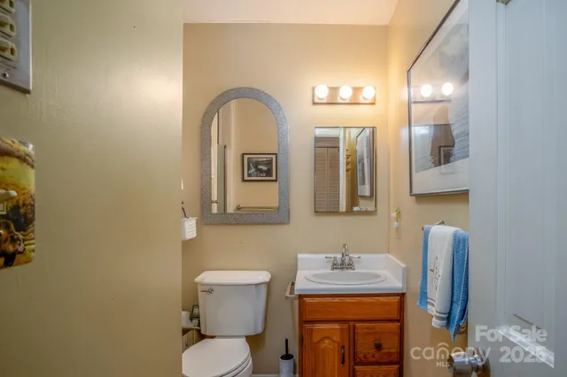 a bathroom with a toilet sink and mirror