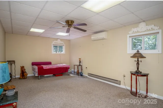 a living room with furniture a window and a chandelier