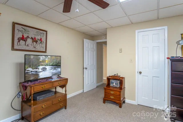 a living room with furniture and a baby crib