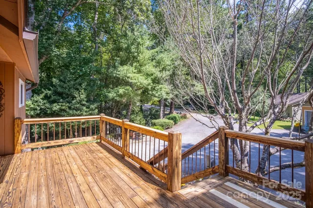 a view of balcony with wooden floor and fence