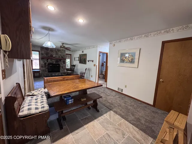 a view of a livingroom with furniture and a ceiling fan
