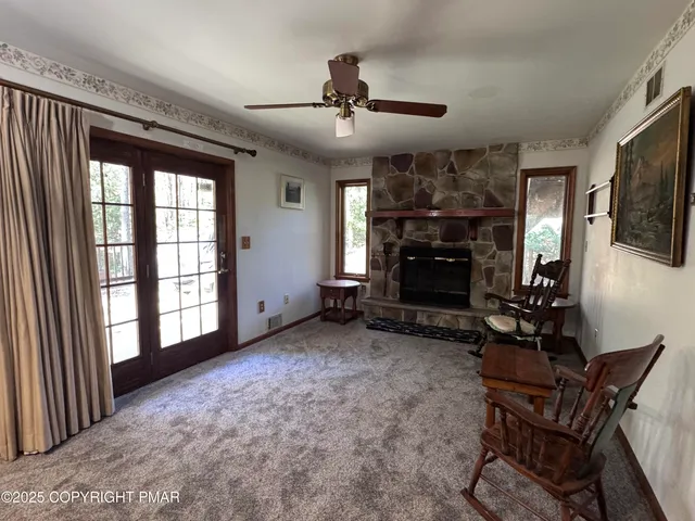 a view of a hallway to a livingroom with a fireplace