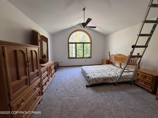 a bedroom with two beds and a chandelier