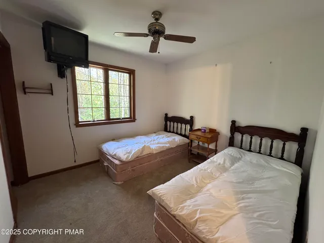 a view of a house with a tree and a yard
