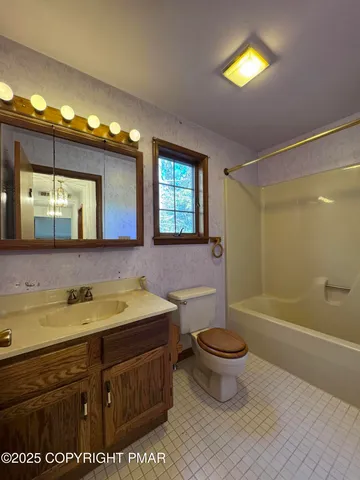 a view of a backyard with wooden fence and a bench