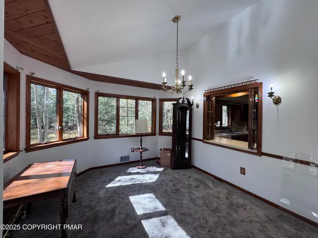 a living room with furniture large window and flat screen tv