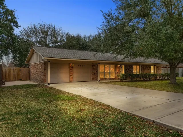a view of a house with a outdoor space and trees