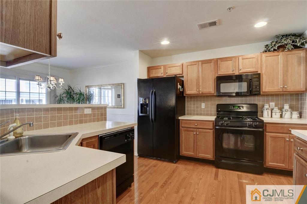 59 Raritan Reach Road, Unit 30 South Amboy, NJ 08879 - Photo 12 of 25 a kitchen with a sink stove and refrigerator