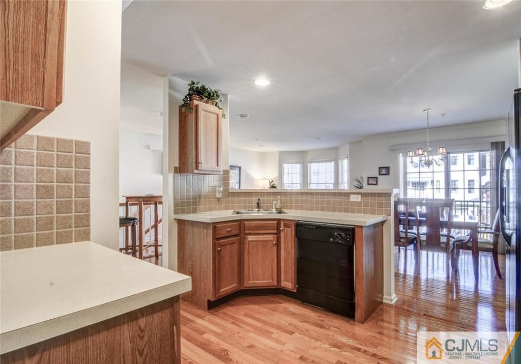 59 Raritan Reach Road, Unit 30 South Amboy, NJ 08879 - Photo 13 of 25 a kitchen with stainless steel appliances granite countertop a stove and cabinets