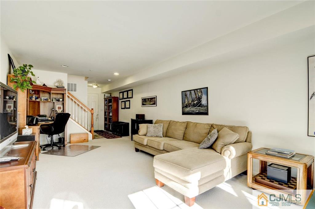 59 Raritan Reach Road, Unit 30 South Amboy, NJ 08879 - Photo 14 of 25 a living room with furniture and a couch