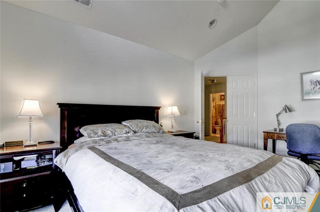 59 Raritan Reach Road, Unit 30 South Amboy, NJ 08879 - Photo 17 of 25 a bedroom with a bed and a lamp