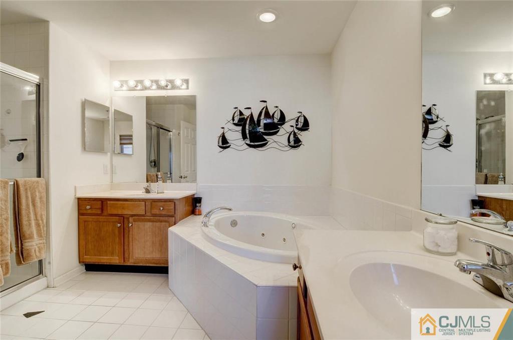 59 Raritan Reach Road, Unit 30 South Amboy, NJ 08879 - Photo 18 of 25 a bathroom with a tub sink and mirror