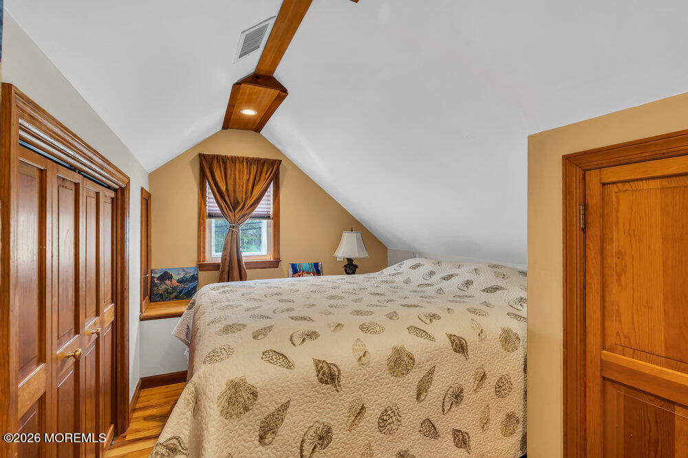 34 State Route Colts Neck, NJ 07722 - Photo 10 of 40 a bedroom with a bed and wooden floor