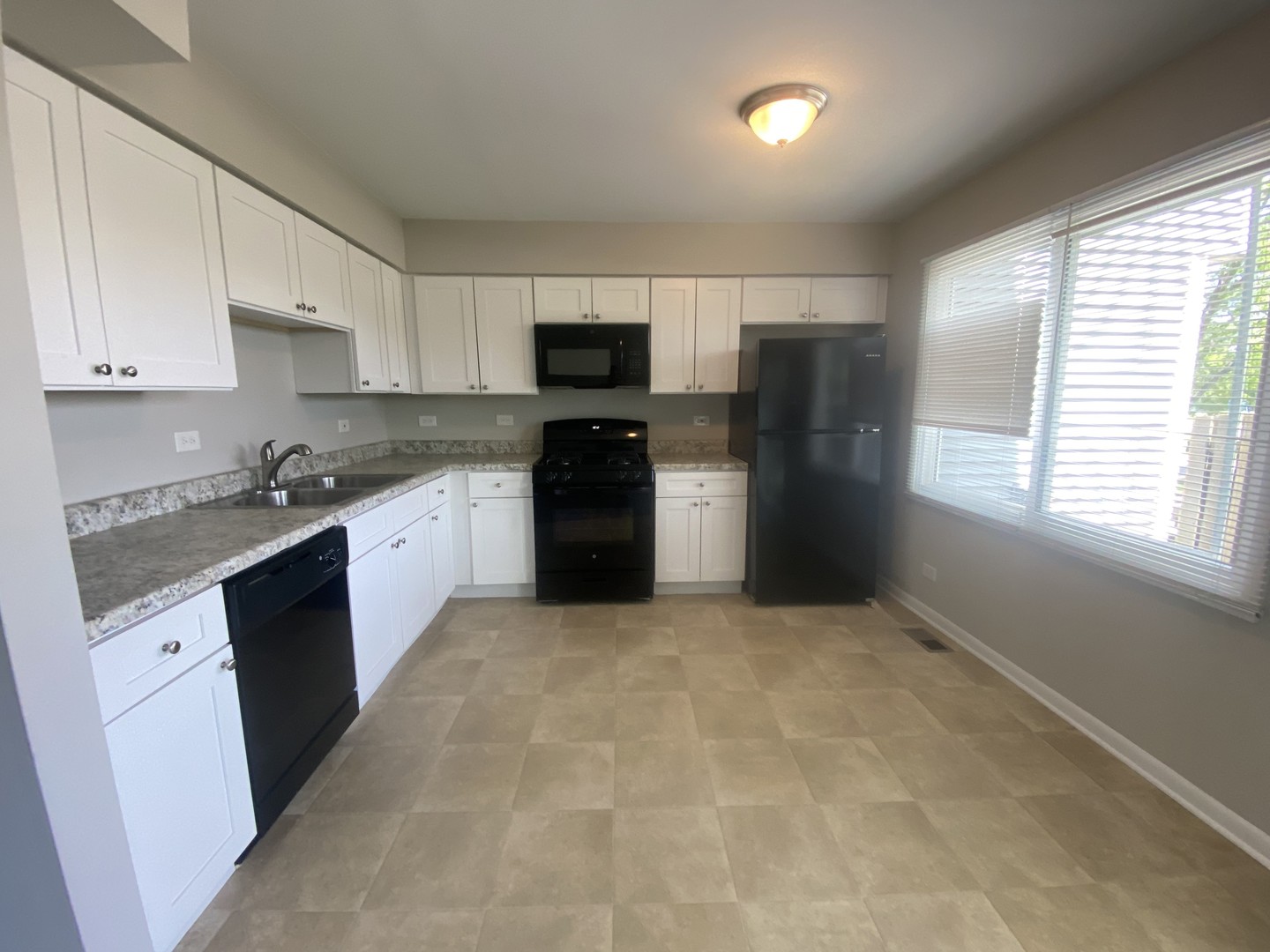 1920 Georgetown Lane Hoffman Estates, IL 60169 - Photo 13 of 28 a kitchen with stainless steel appliances granite countertop a stove a sink and a refrigerator
