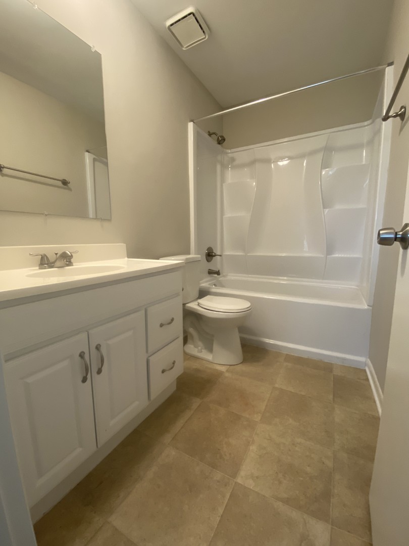1920 Georgetown Lane Hoffman Estates, IL 60169 - Photo 24 of 28 a bathroom with a double vanity sink toilet mirror and shower