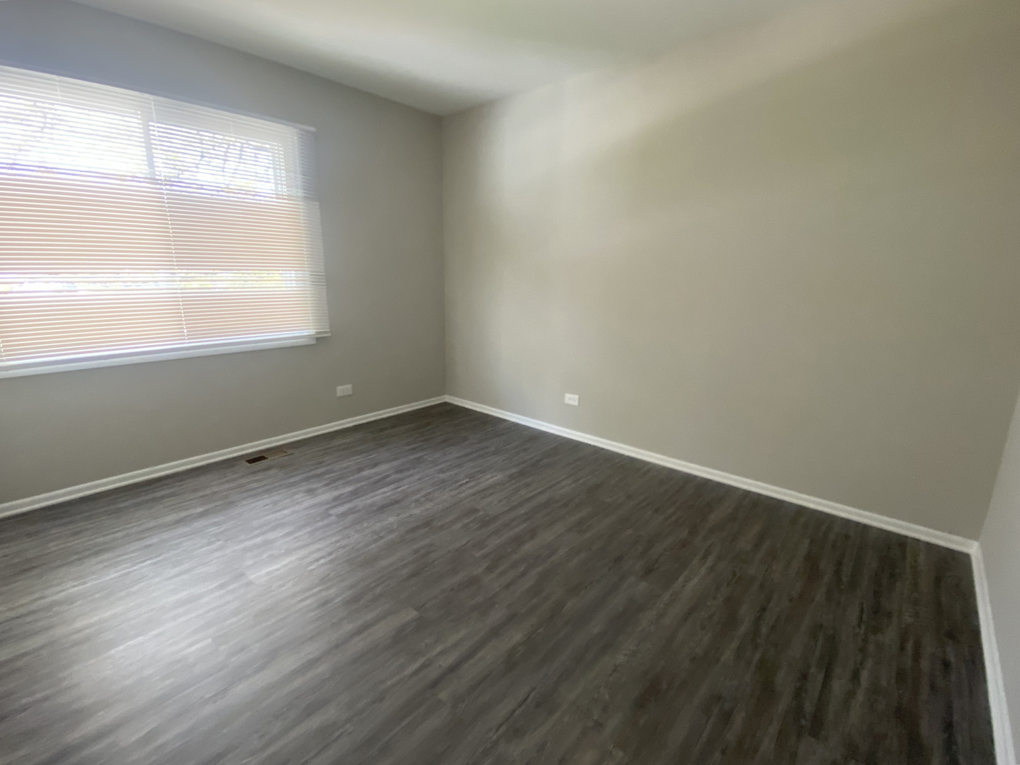 1920 Georgetown Lane Hoffman Estates, IL 60169 - Photo 25 of 28 a view of an empty room with wooden floor and a window