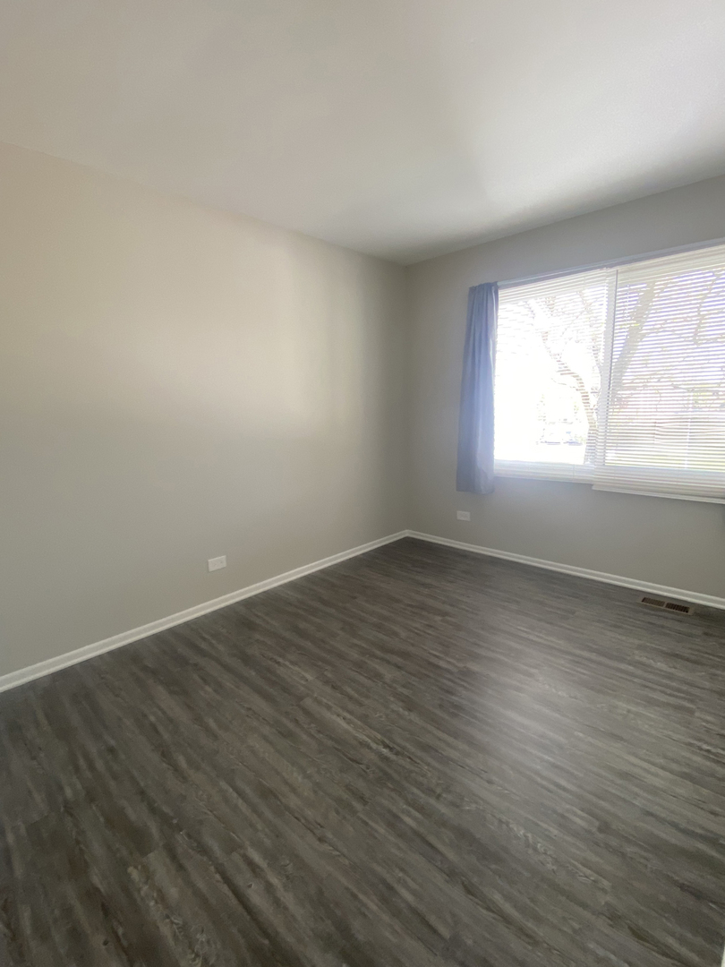 1920 Georgetown Lane Hoffman Estates, IL 60169 - Photo 26 of 28 an empty room with wooden floor and windows