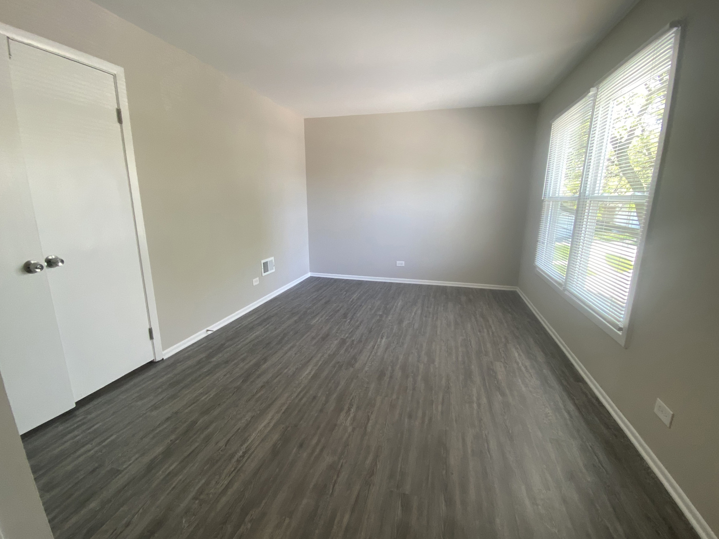 1920 Georgetown Lane Hoffman Estates, IL 60169 - Photo 27 of 28 an empty room with wooden floor and windows
