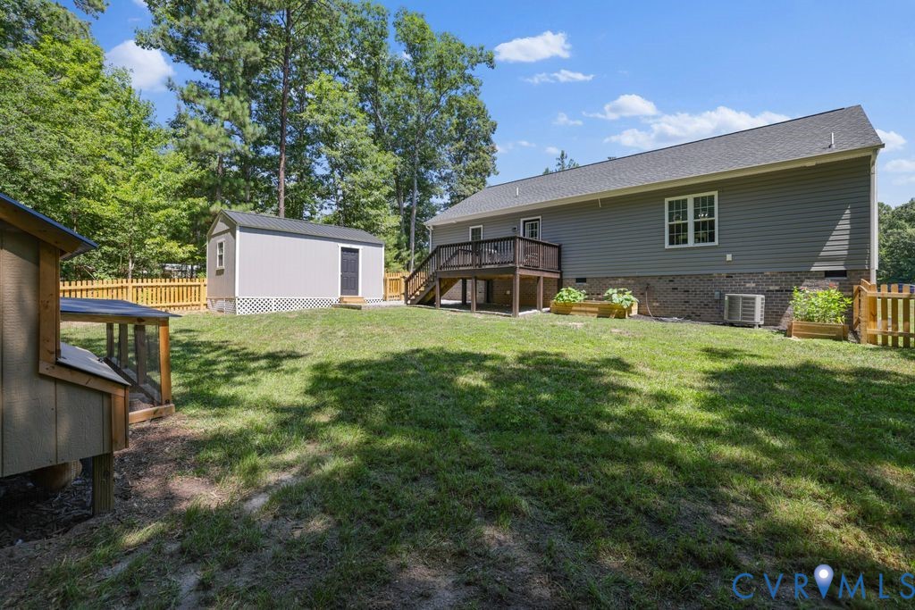 222 Oak Ridge Court Aylett, VA 23009 - Photo 31 of 35 Spacious backyard featuring a sloped lawn, a large