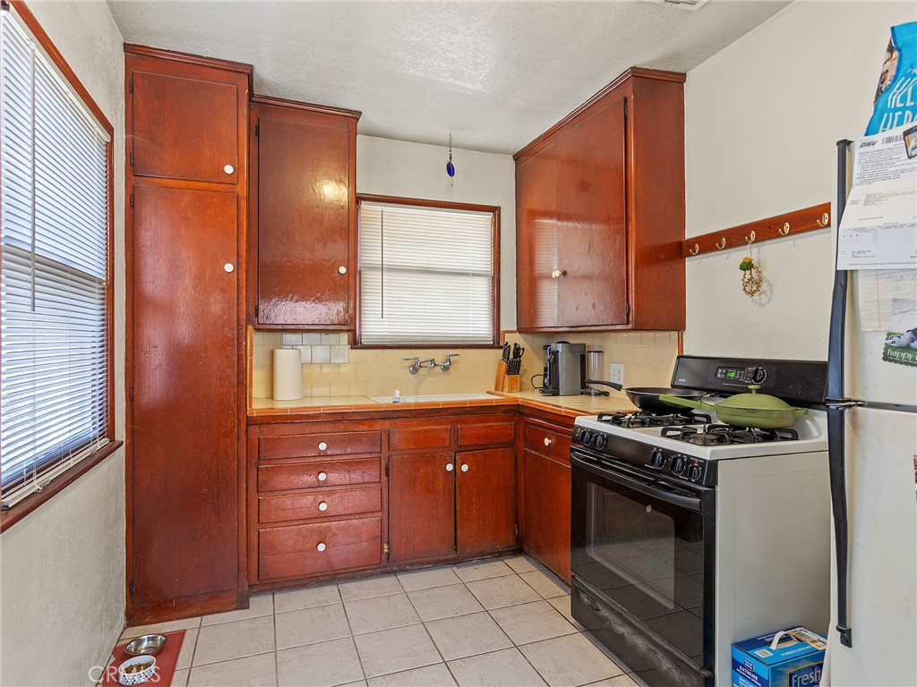 331 Allen Avenue Glendale, CA 91201 - Photo 25 of 61 a kitchen with stainless steel appliances granite countertop a stove a sink and a refrigerator