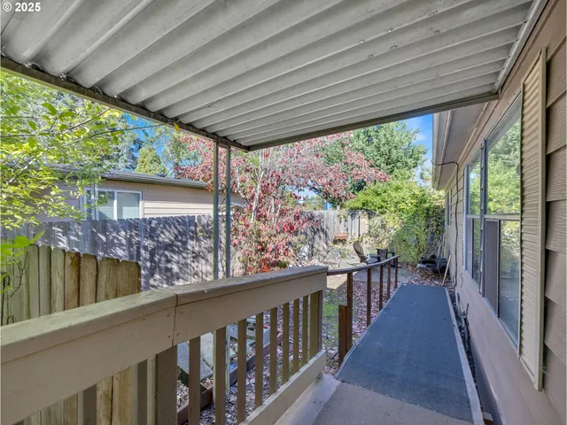 a view of a pathway of a house with wooden fence