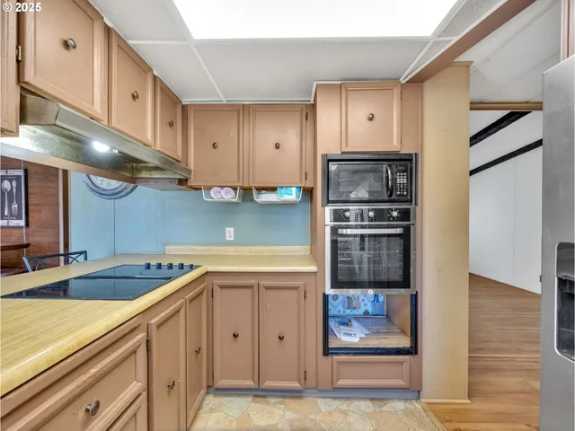 a kitchen with a sink cabinets and stainless steel appliances