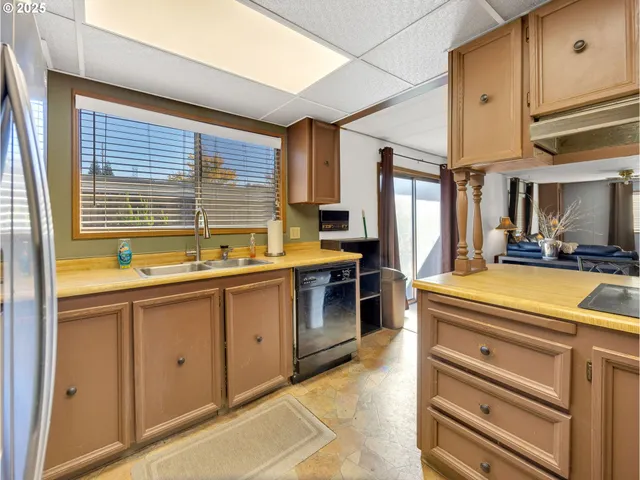 a kitchen with stainless steel appliances granite countertop a sink and cabinets