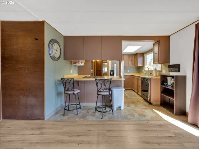 a view of a kitchen with dining table and chairs