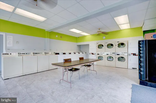 a kitchen with stainless steel appliances a white cabinets and a refrigerator