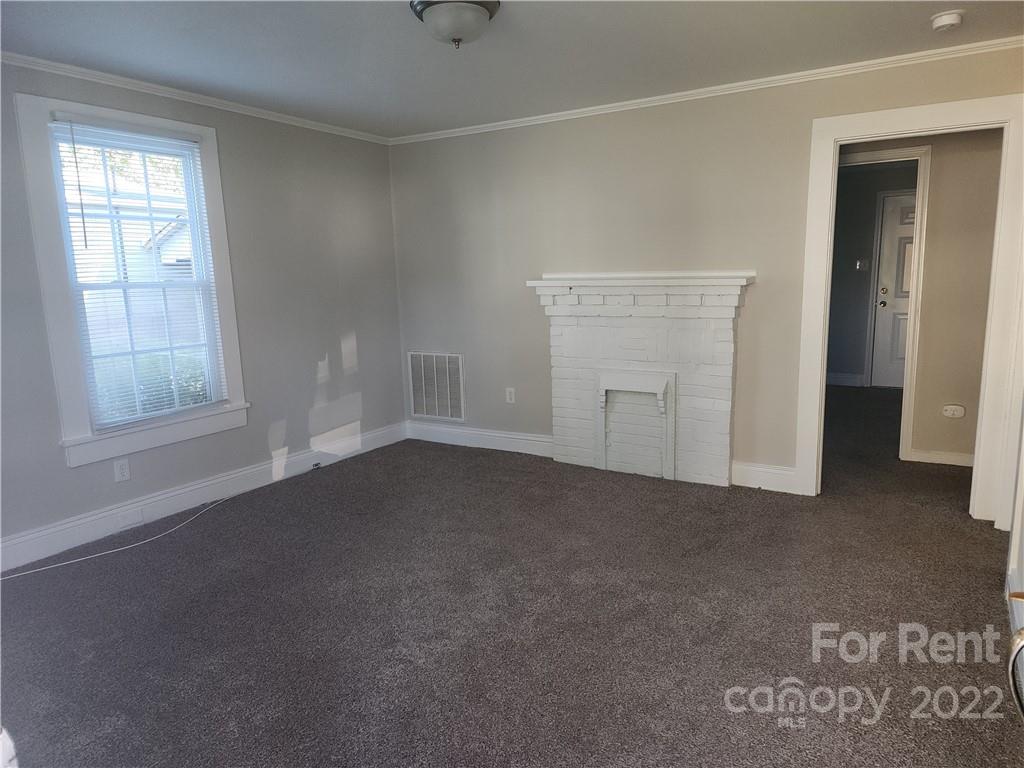 307 Rice Street Kannapolis, NC 28081 - Photo 5 of 7 an empty room with windows and closet