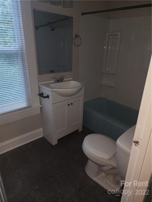 307 Rice Street Kannapolis, NC 28081 - Photo 6 of 7 a white toilet sitting next to a bathroom sink