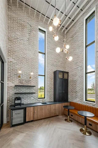 a living room with furniture flat screen tv and a large window