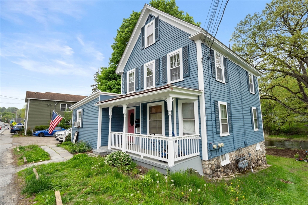 26 Powder Mill Road Maynard, MA 01754 - Photo 9 of 16 a view of a house with a yard and plants