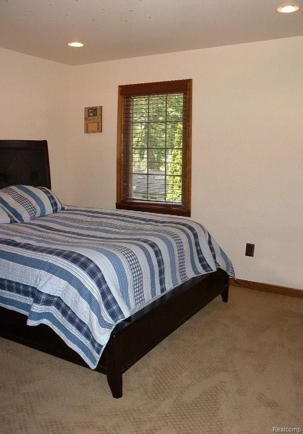 2478 Pembroke Road Birmingham, MI 48009 - Photo 28 of 38 Bedroom #2 with neutral carpet & paint, recessed lights, full wall closet with 6-panel doors