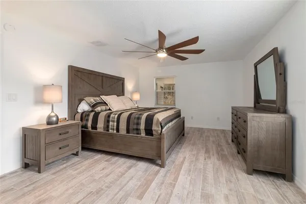 a bedroom with a bed and a night stand