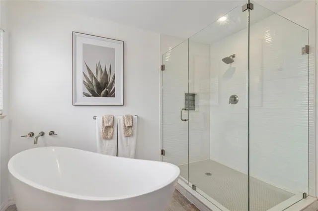 a bathroom with a tub sink and shower