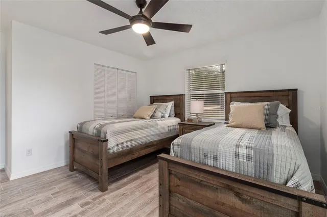 a bedroom with two beds and painting on the wall