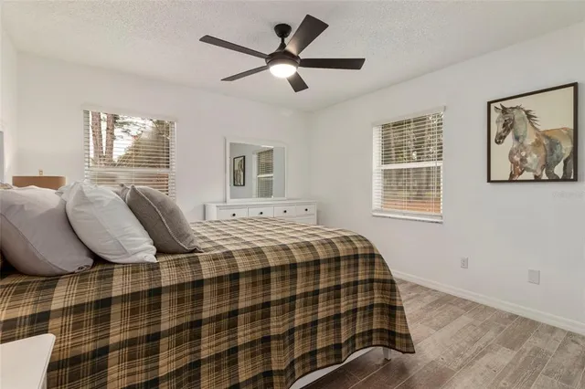 a bedroom with a bed and wooden floor