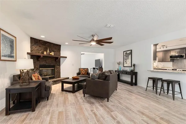 a living room with furniture a fireplace and a flat screen tv
