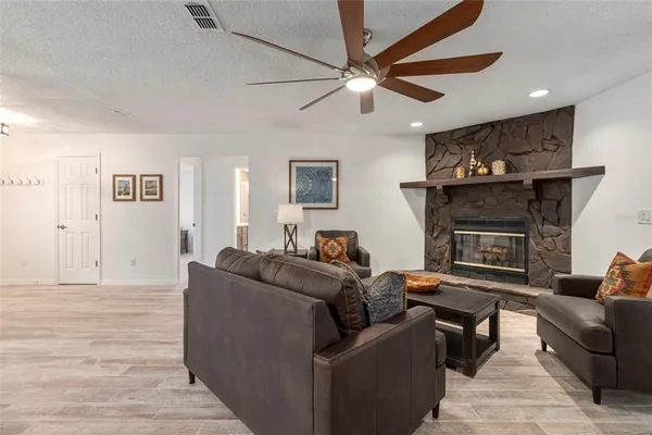 a living room with furniture and a fireplace