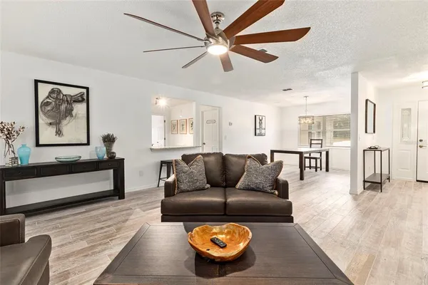 a living room with furniture and a wooden floor