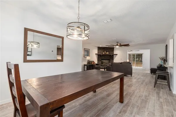 a view of a dining room with furniture wooden floor and chandelier