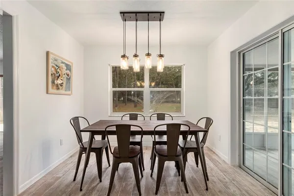 a view of a dining room with furniture and window