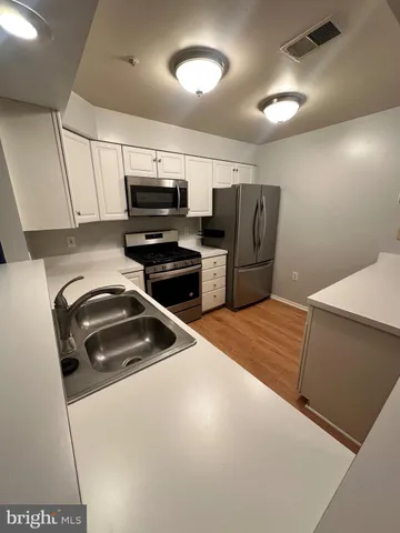 a kitchen with refrigerator and microwave