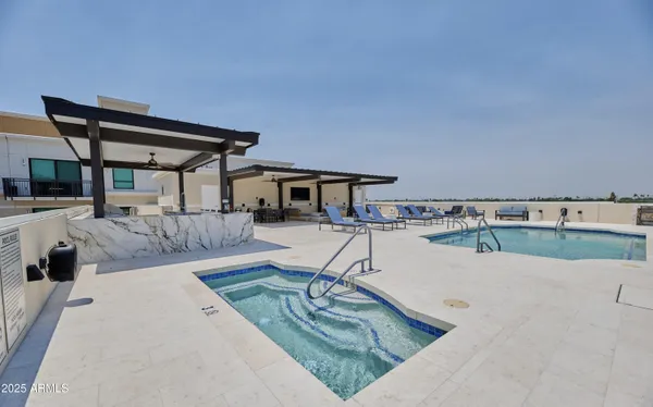 a view of swimming pool with seating space