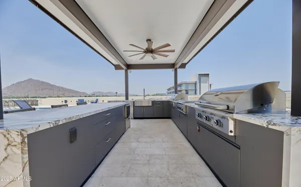 a large kitchen with a stove and a sink