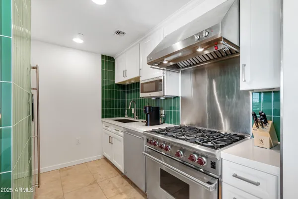 a kitchen with a stove and a wooden floors