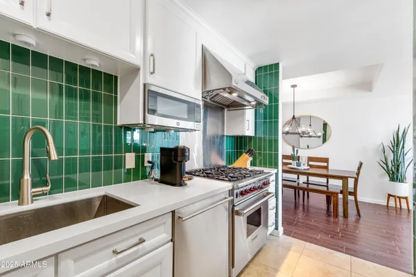 a kitchen with furniture wooden floor and a sink