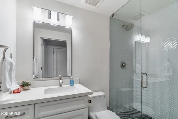 a bathroom with a sink toilet and shower