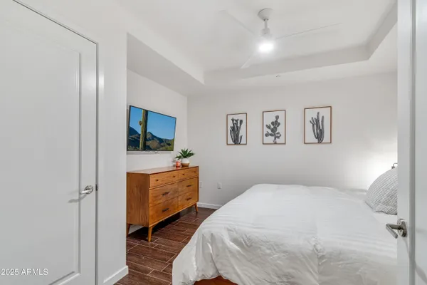 a bedroom with a bed and a flat screen tv
